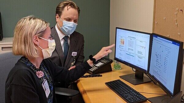 Two people looking at a computer