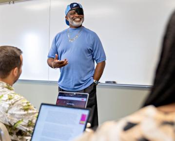 Individual standing in front of classroom