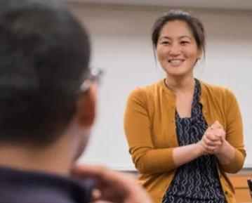 Faculty member smiling at student