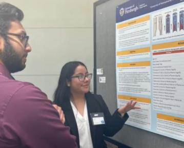 student presenting poster
