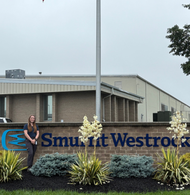 Conte in front of Smurfit Westrock sign
