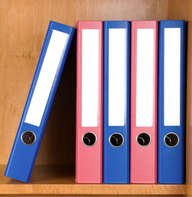 binders on wooden shelf