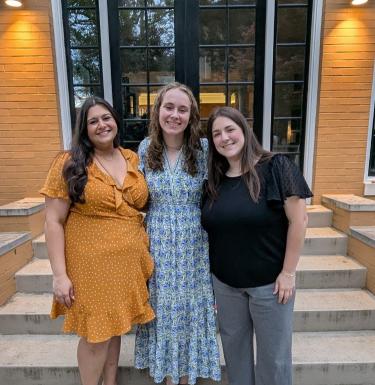 three HPM students at department celebration