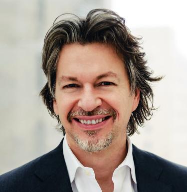 Man smiling in a white collared shirt