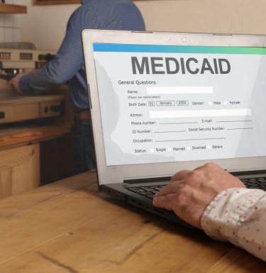 person on computer looking up medicaid