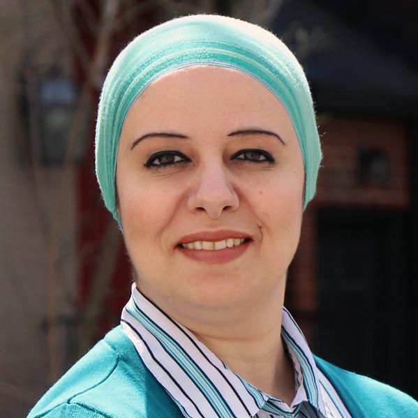 Headshot of a woman wearing blue sweater and blue headscarf