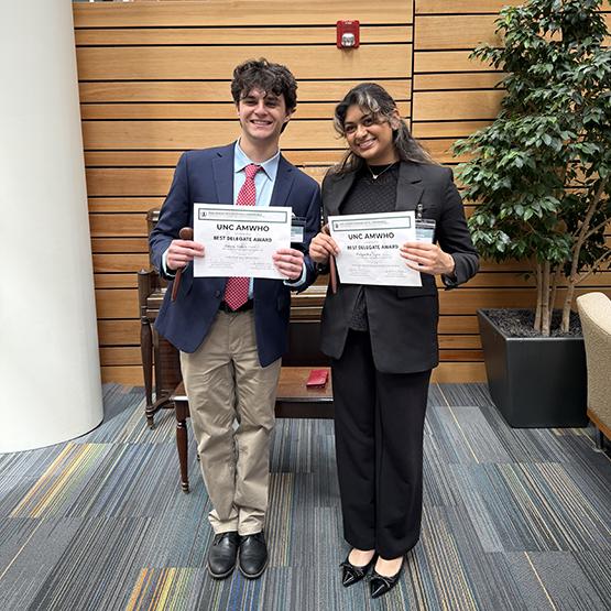 Students hold up their awards 