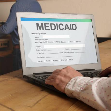 person on computer looking up medicaid