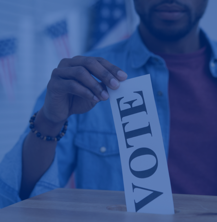 person adding ballot to box